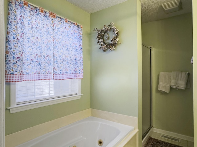5505 Indigo Makers Trce, Charleston, SC 29418 - full bath with a textured ceiling, visible vents, a tub with jets, and a stall shower
