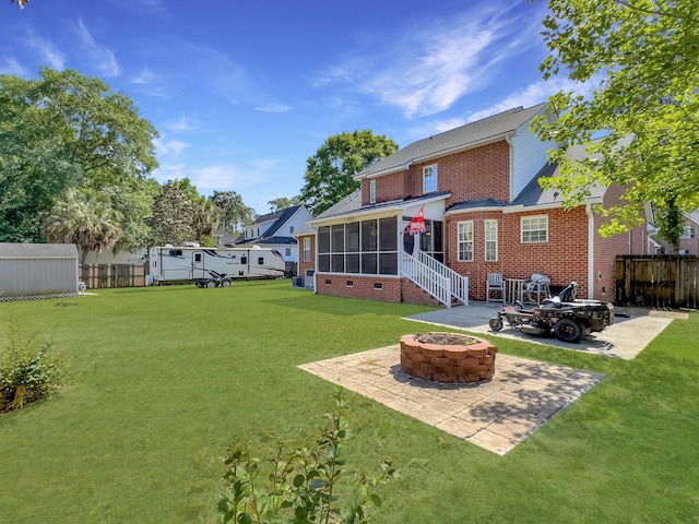 5505 Indigo Makers Trce, Charleston, SC 29418 - back of house with a fire pit, fence, a patio, a sunroom, and a yard