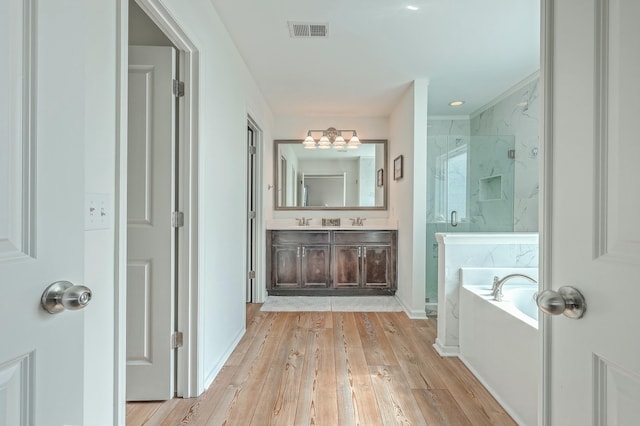 bathroom featuring vanity, shower with separate bathtub, and wood-type flooring