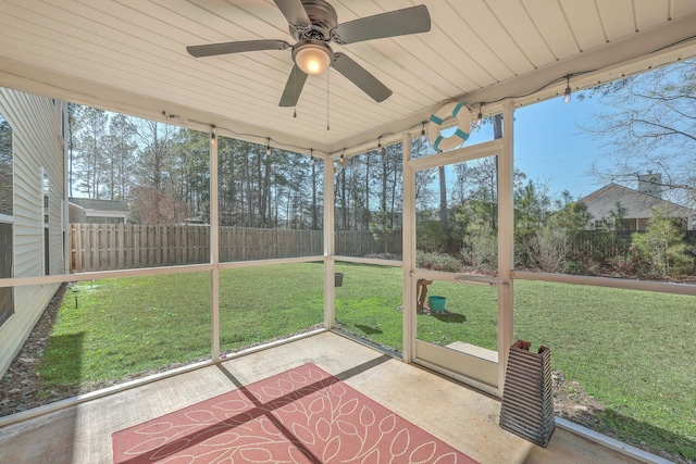 unfurnished sunroom featuring ceiling fan and a healthy amount of sunlight