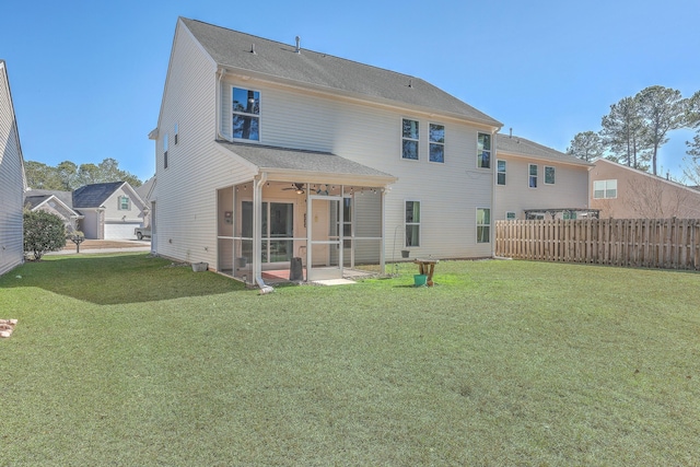 rear view of property with a lawn, a sunroom, ceiling fan, and a patio area