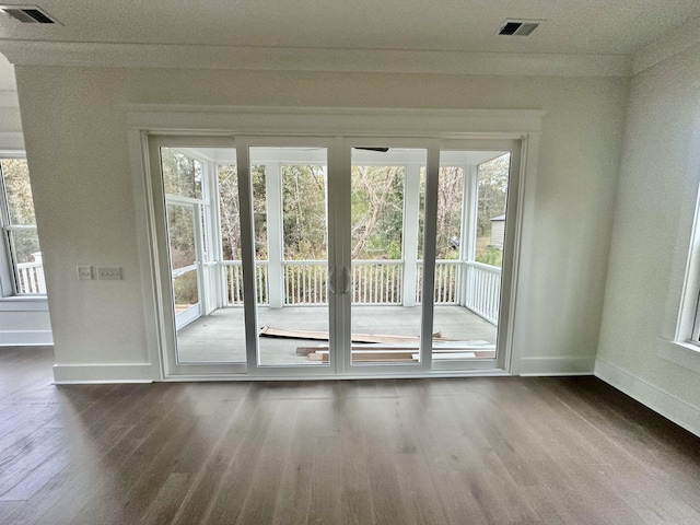 entryway with a healthy amount of sunlight and hardwood / wood-style floors