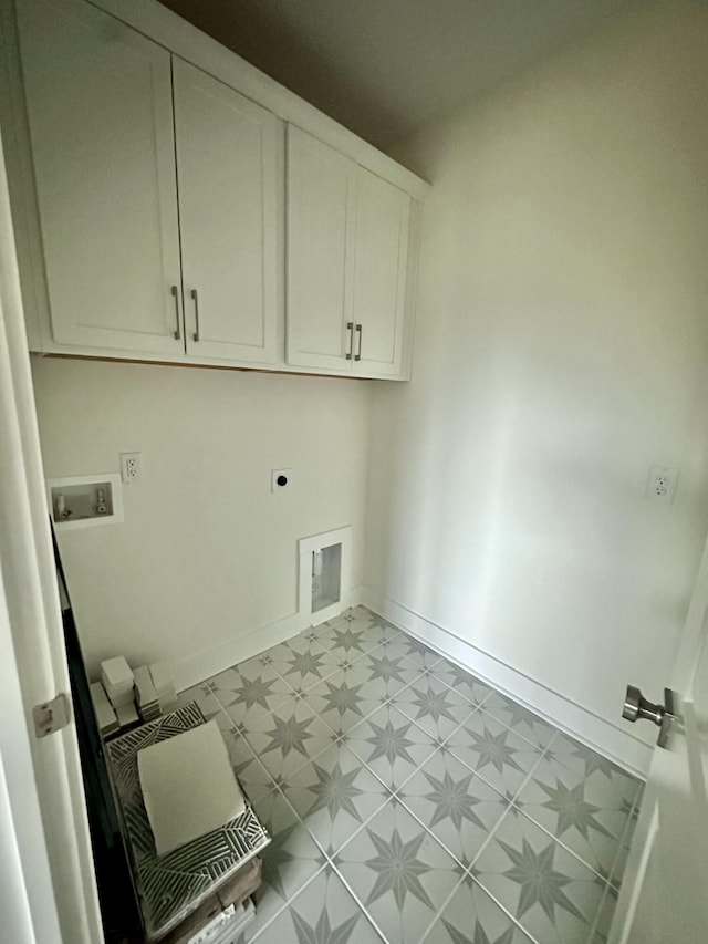 clothes washing area with electric dryer hookup, washer hookup, and cabinets