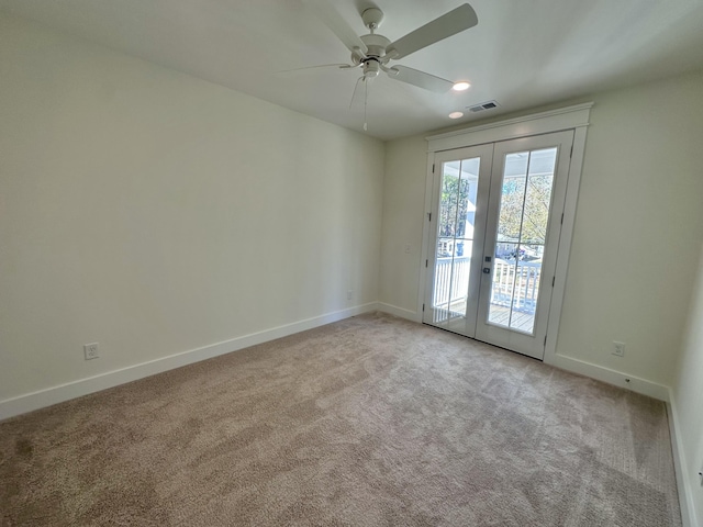 carpeted empty room featuring french doors and ceiling fan