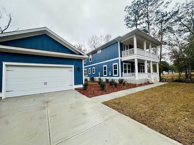 view of front facade featuring a garage, a front lawn, a balcony, and a porch