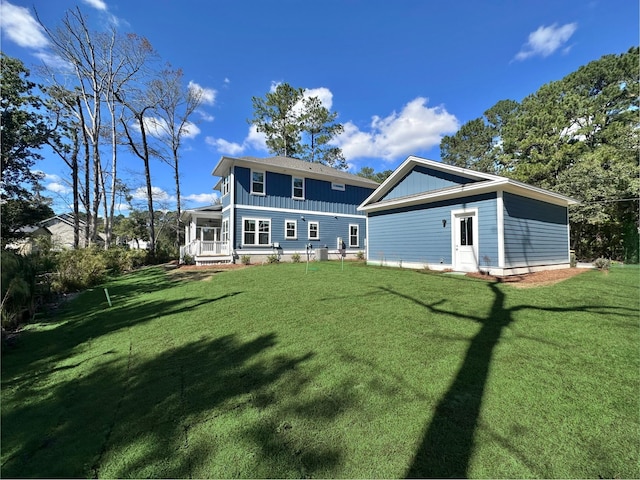 rear view of house with a lawn