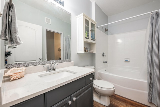 full bathroom featuring shower / bathtub combination with curtain, toilet, vanity, and hardwood / wood-style flooring