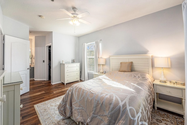 bedroom with ceiling fan, dark hardwood / wood-style floors, ensuite bath, and a closet