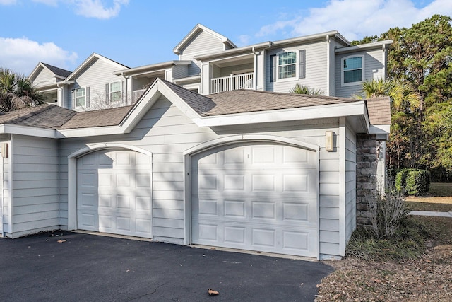 exterior space featuring a balcony and a garage