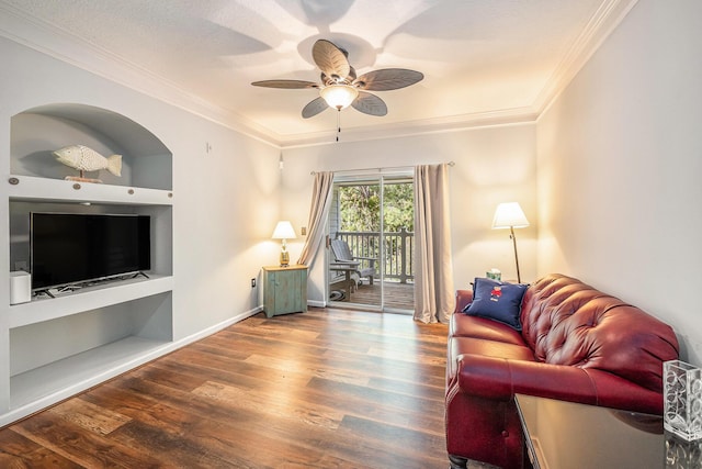 living room featuring wood-type flooring, ceiling fan, and crown molding