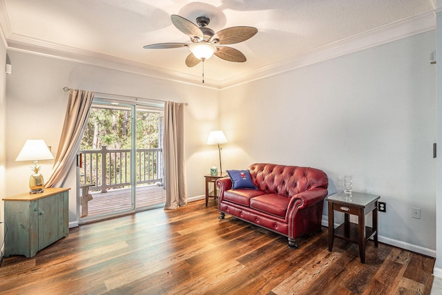 living area featuring crown molding, ceiling fan, dark wood-type flooring, and a textured ceiling