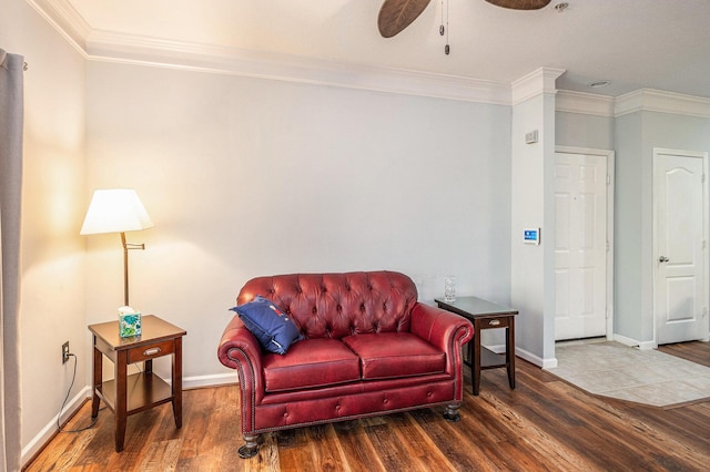 sitting room with ceiling fan, dark wood-type flooring, and ornamental molding