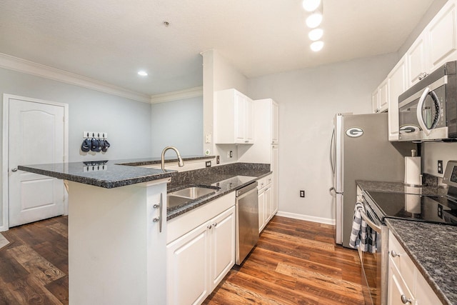 kitchen with kitchen peninsula, white cabinetry, sink, and appliances with stainless steel finishes