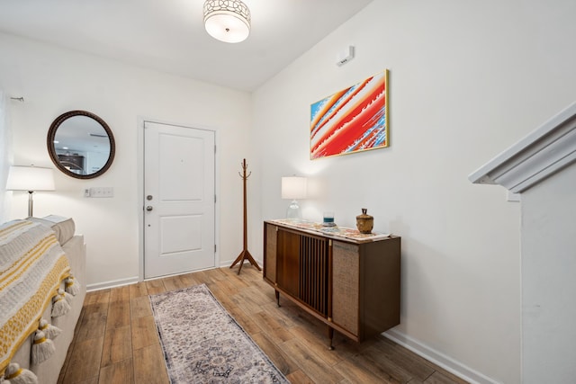 foyer entrance featuring wood finished floors and baseboards