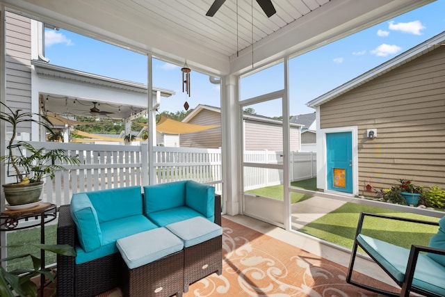 sunroom / solarium featuring a ceiling fan and an outdoor hangout area