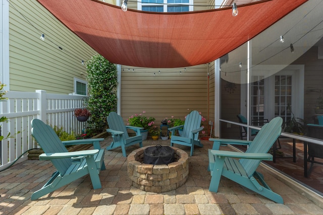 view of patio / terrace featuring a fire pit and fence
