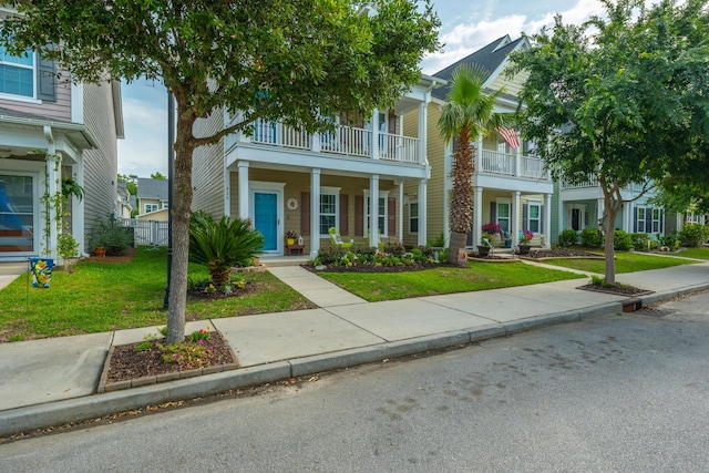 view of front of property featuring a balcony and a porch