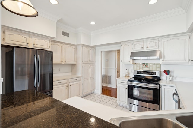 kitchen with light tile patterned floors, crown molding, and appliances with stainless steel finishes