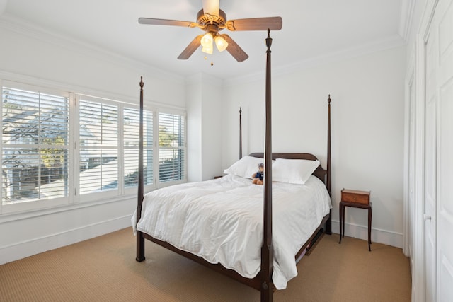 bedroom featuring light colored carpet, ceiling fan, and crown molding