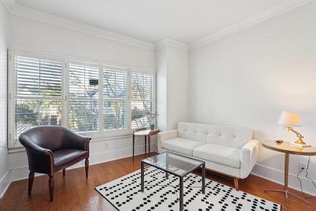 sitting room with hardwood / wood-style floors and crown molding