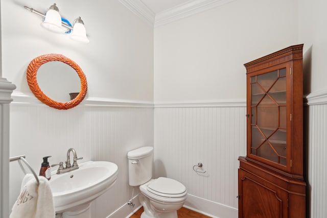 bathroom with crown molding, sink, and toilet