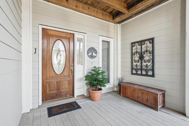 view of exterior entry with covered porch