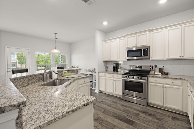 kitchen featuring a sink, decorative backsplash, stainless steel appliances, and recessed lighting