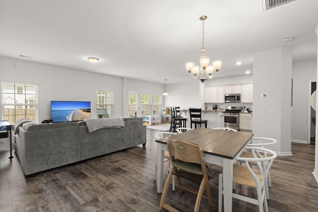 dining space with visible vents, baseboards, dark wood-style floors, an inviting chandelier, and recessed lighting