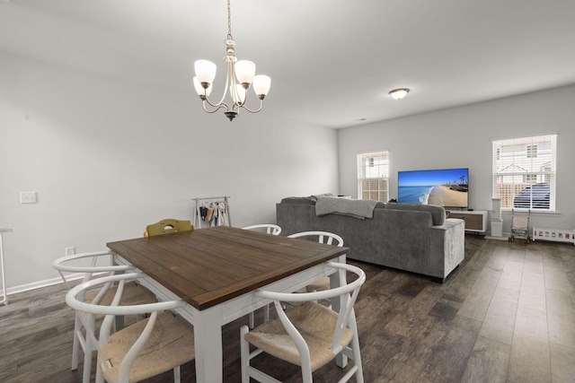 dining room featuring an inviting chandelier and dark wood-type flooring