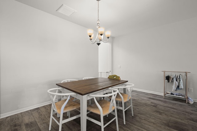 dining space with visible vents, dark wood-style flooring, baseboards, and an inviting chandelier