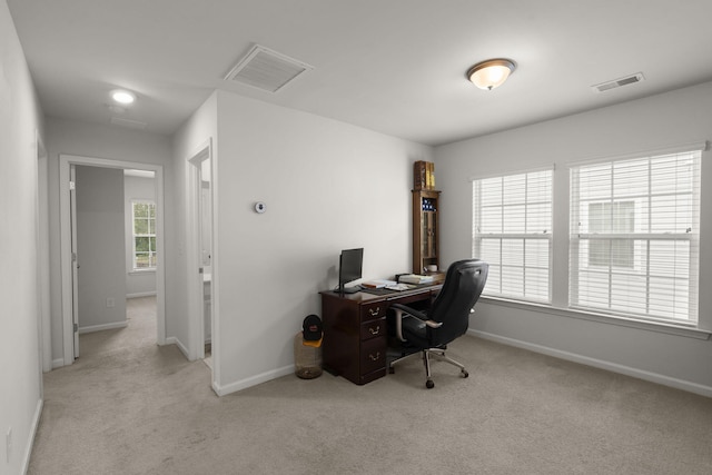 home office featuring carpet flooring, baseboards, and visible vents