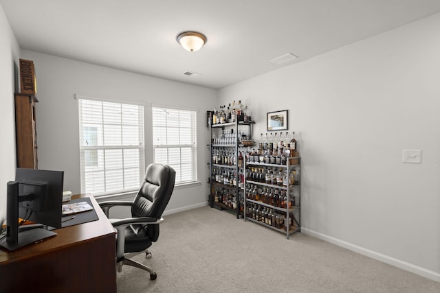 carpeted office space with baseboards, a dry bar, and visible vents