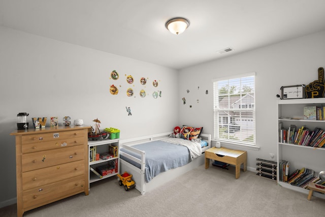 carpeted bedroom featuring visible vents