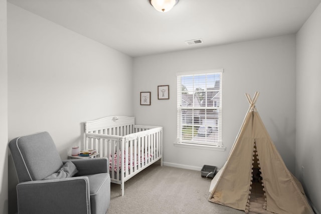 carpeted bedroom featuring a nursery area, baseboards, and visible vents