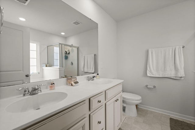 full bath with a sink, a stall shower, toilet, and double vanity