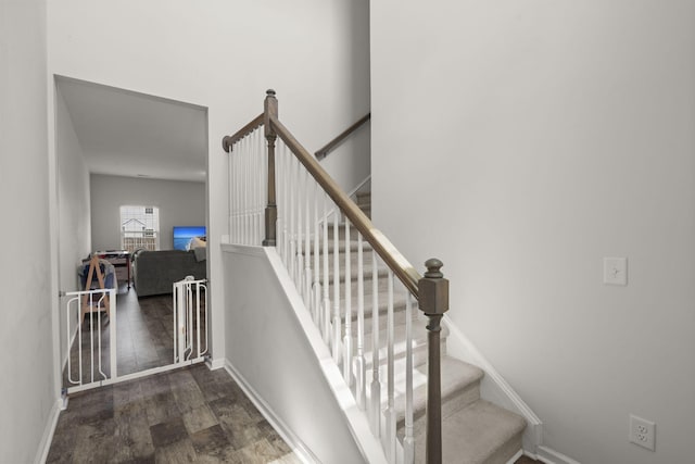 staircase featuring baseboards