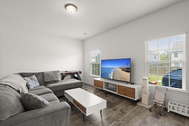living room with baseboards and dark wood-style flooring