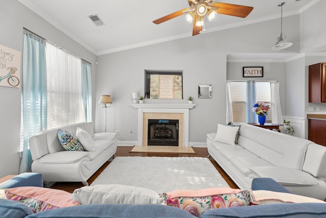 living room featuring hardwood / wood-style flooring, vaulted ceiling, ceiling fan, and crown molding