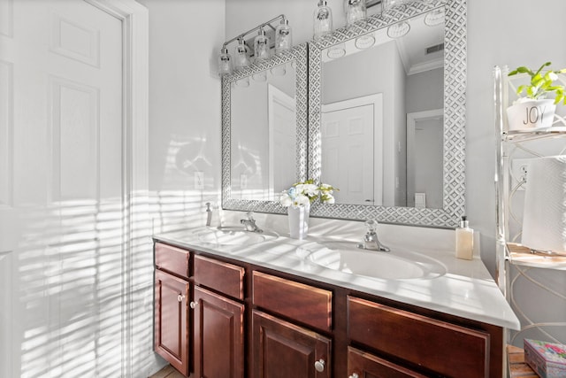 bathroom featuring vanity and ornamental molding