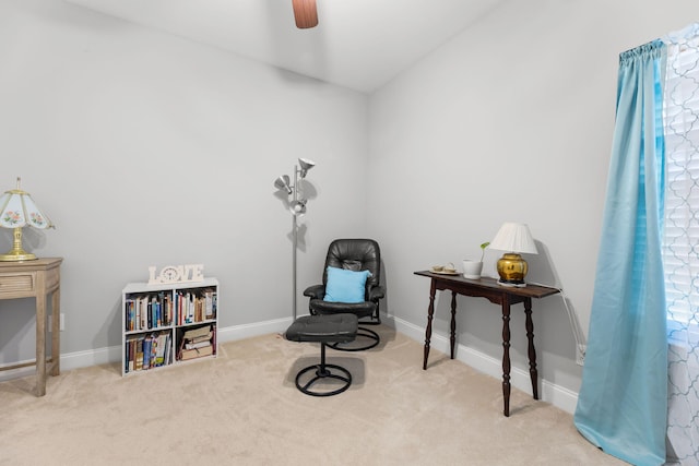 sitting room featuring light carpet and ceiling fan