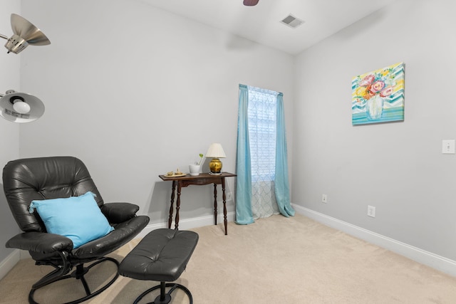 sitting room featuring light carpet