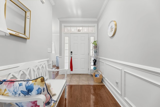 entryway featuring ornamental molding and hardwood / wood-style flooring