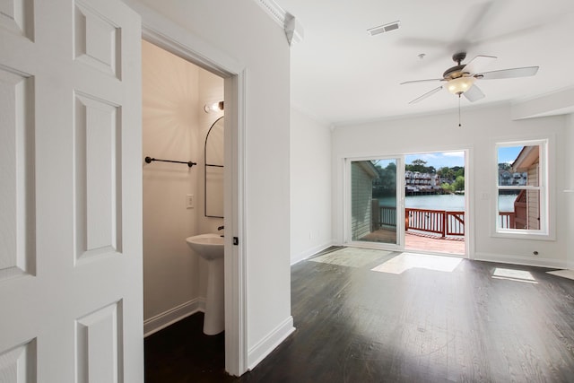 bathroom featuring visible vents, baseboards, a ceiling fan, wood finished floors, and crown molding
