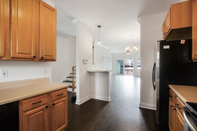 kitchen with appliances with stainless steel finishes, light countertops, baseboards, a notable chandelier, and dark wood-style floors