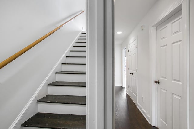 stairway with recessed lighting, wood finished floors, and baseboards