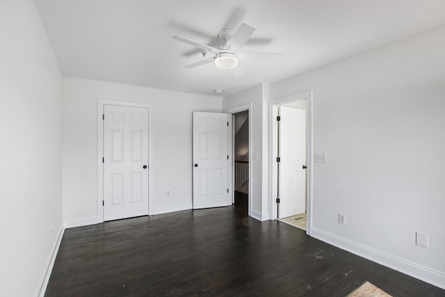 unfurnished bedroom with dark wood finished floors, baseboards, and ceiling fan