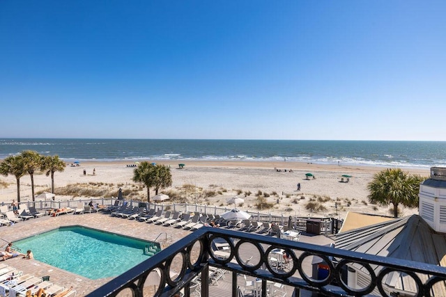 view of water feature with a beach view and fence