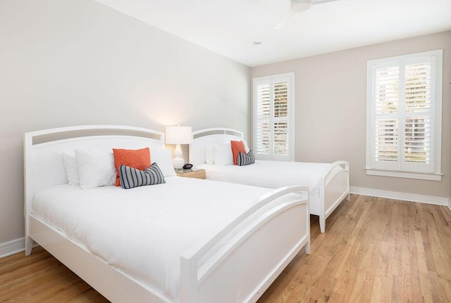 bedroom with light wood-style flooring and baseboards