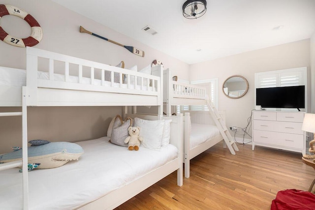 bedroom with visible vents and light wood-type flooring