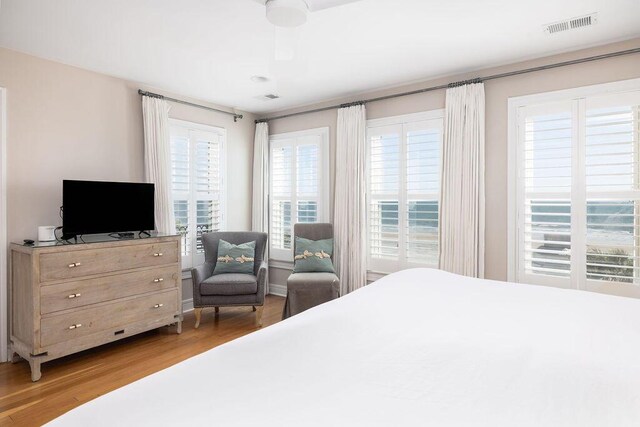 bedroom featuring visible vents and wood finished floors